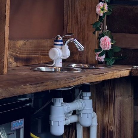 Sink with hot and cold mixer tap set into the wooden counter