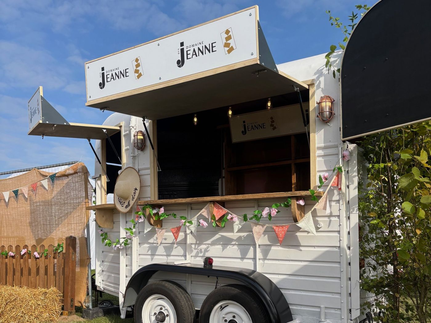 The Horseless Bar dressed with bunting and roses at CarFest