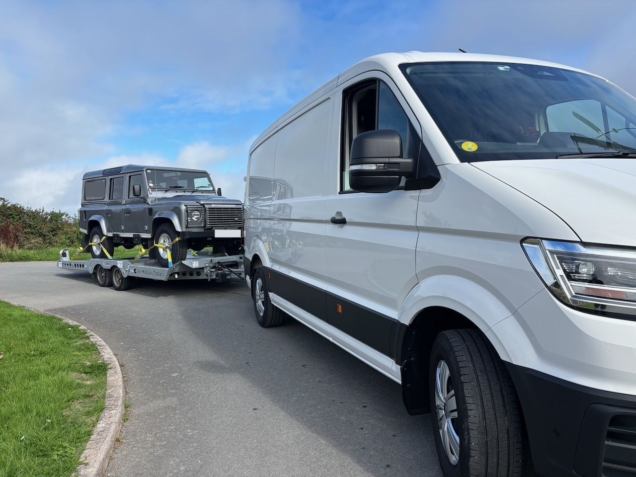 Tryc's VW Crafter towing a Land Rover Defender on a car transporter trailer